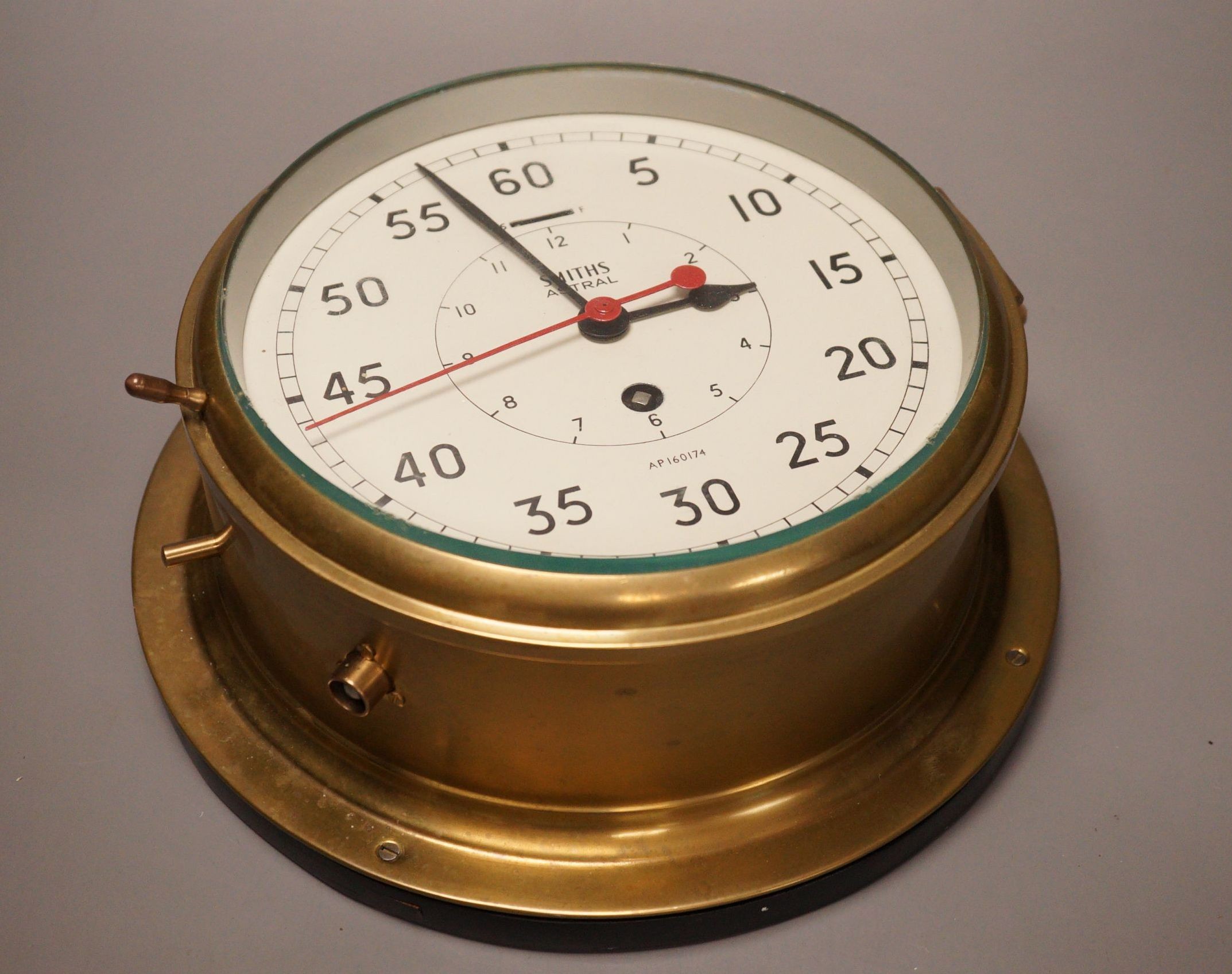 A Smiths Astral brass ships bulkhead timepiece, 27cm